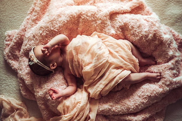 Little cute newborn baby girl in the bed