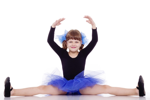 Little dancer in a beautiful blue dress isolated on a white background