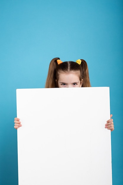 Little dark hair kid with white board