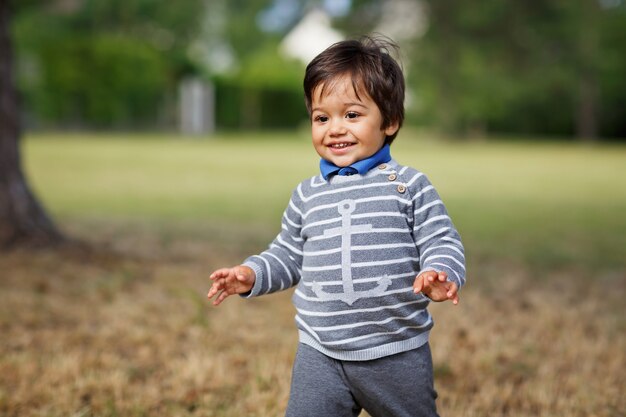 Little eastern handsome baby boy playing outdoor in the park