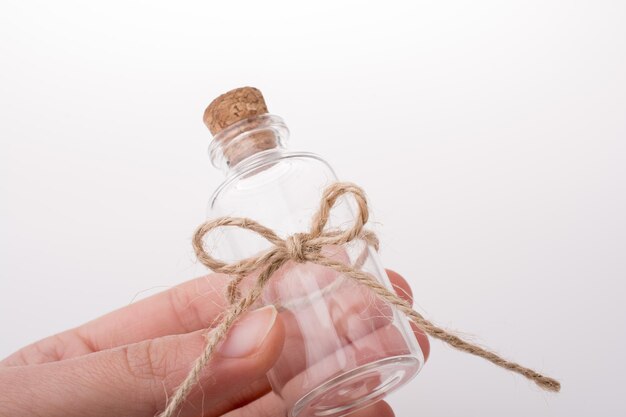 Little empty glass bottle in hand