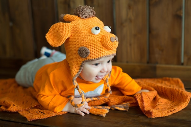 Little European baby in bright orange clothes