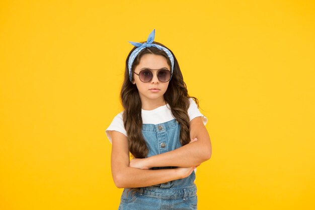 Little fashionista Cute kid fashion girl Summer fashion concept UV protection Girl long curly hair sunglasses tied head scarf Fashion trend You can have anything you want if dress for it