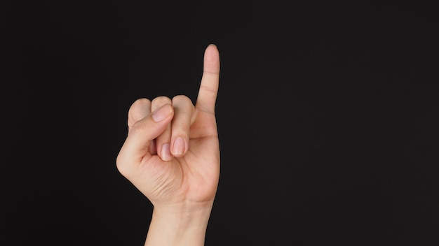 Photo little finger or pinkie gesture hand sign on black background