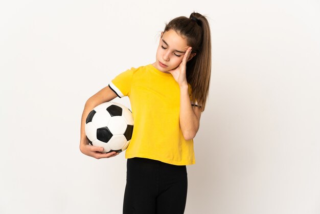 Little football player girl isolated on white background with headache