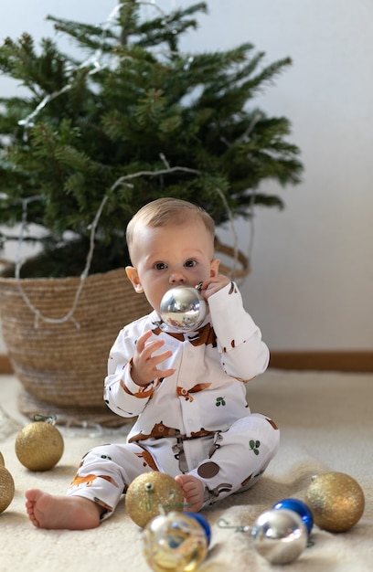 Little funny boy sitting near new year eve