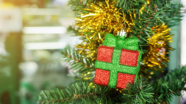 Little gift box hanging on a Christmas tree