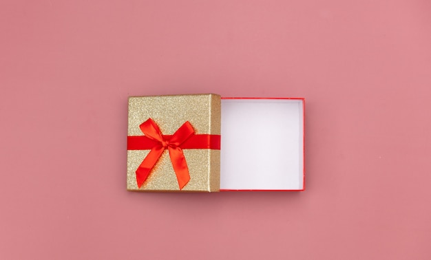 Little gift box on pink background.