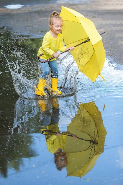 little girl on an active and fun walk through the puddles