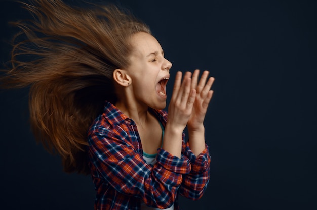 Little girl against powerful airflow, developing hairstyle effect