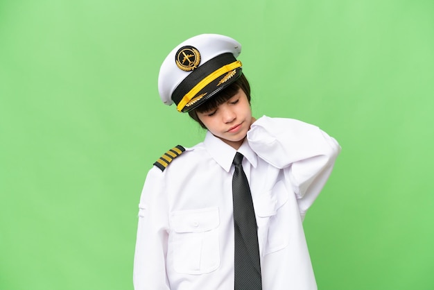 Little girl as a Airplane pilot over isolated chroma key background with neckache