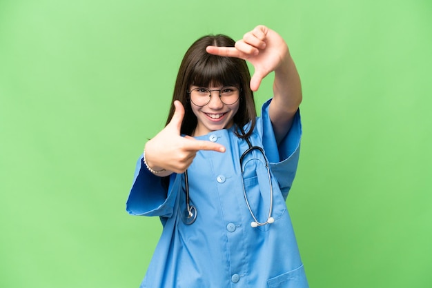 Little girl as a surgeon doctor over isolated chroma key background focusing face Framing symbol