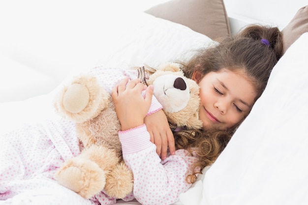 little girl asleep with her teddy bear