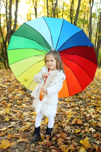 Little girl in autumn forest