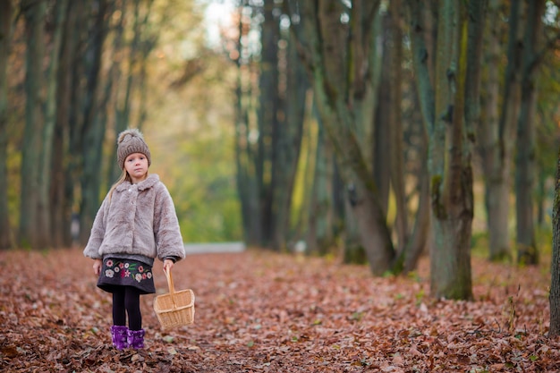 Little girl in autumn park outdoors