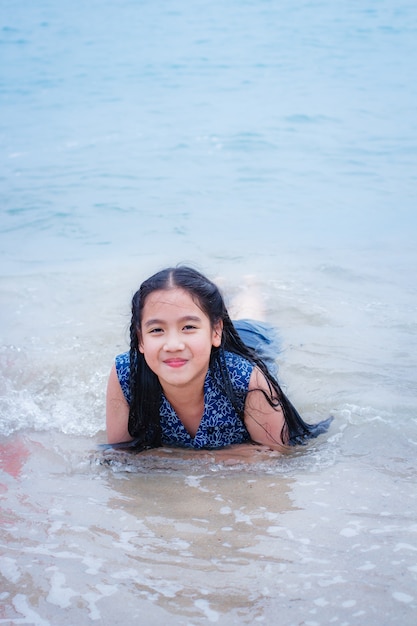 Little girl on the beach in summer day.