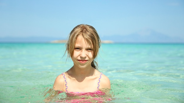 Little girl on the beach on summer