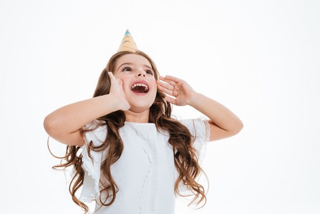 little girl in birthday hat