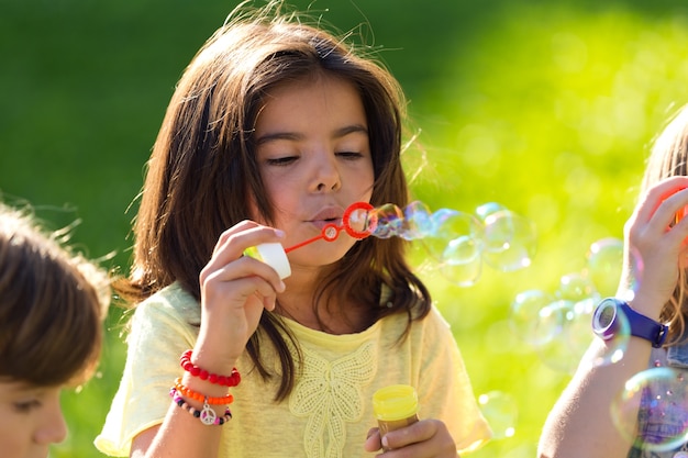 Little girl blowing bubbles