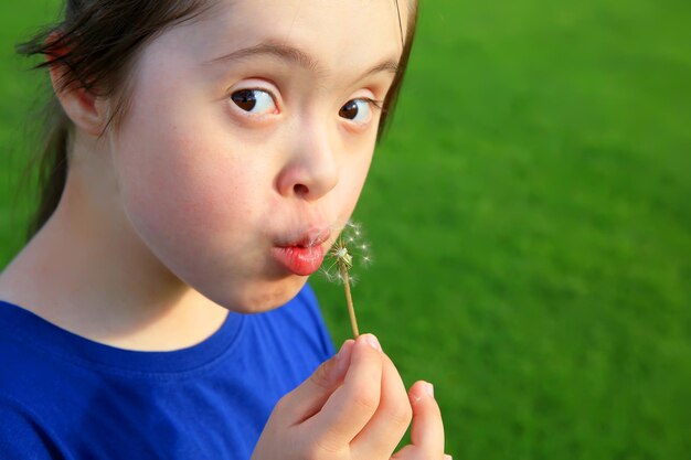 Little girl blowing dandelion