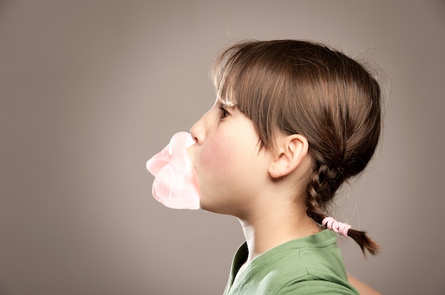 little girl blowing gum