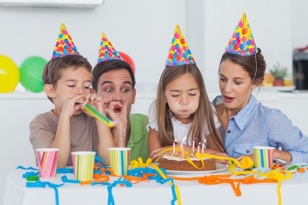 Little girl blowing her candles during her birthday party