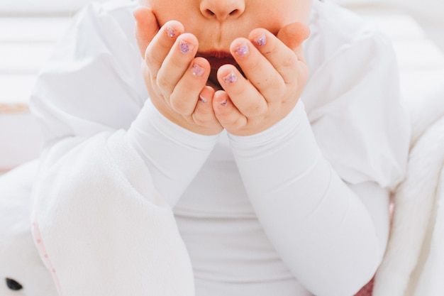 Little girl blowing a kiss with her hands