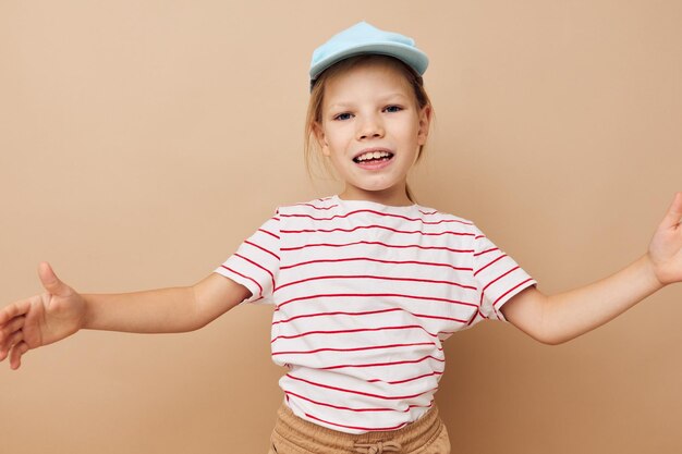 Little girl in blue caps striped tshirt emotions Lifestyle unaltered