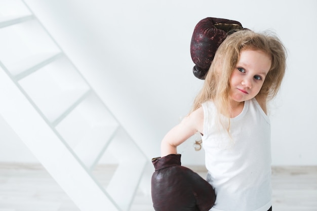 Little girl in boxing gloves.