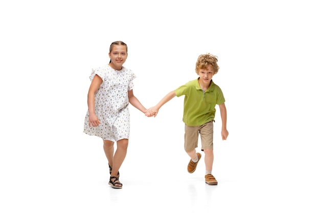 Little girl and boy running isolated on white background, happy