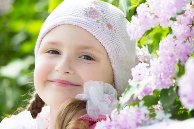 Little Girl in the branches of lilac