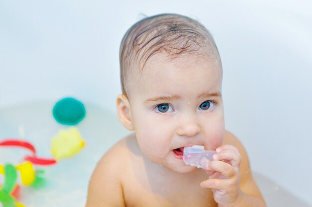 A little girl brushes her teeth in the bathroom. portrait of a child with a toothbrush