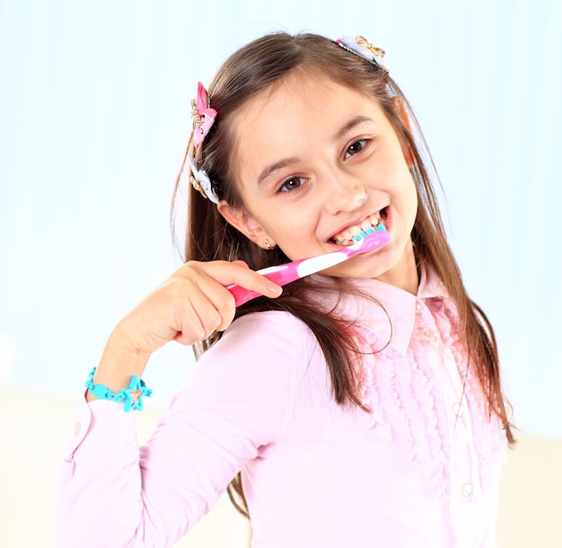 The little girl brushing her teeth.