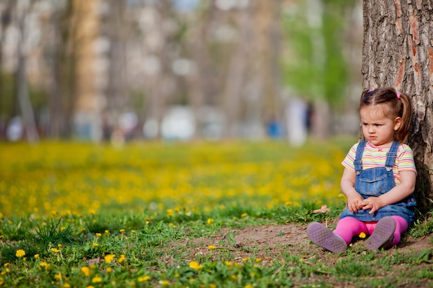 Little girl by the tree