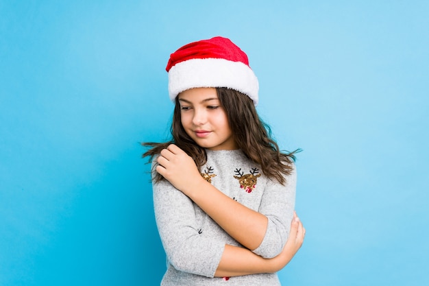 평온하고 행복 미소 크리스마스 날 포옹을 축하하는 어린 소녀.