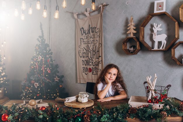 little girl in christmas lights and decorations