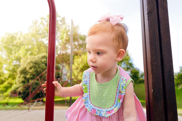 Little girl climbing and playing at the park