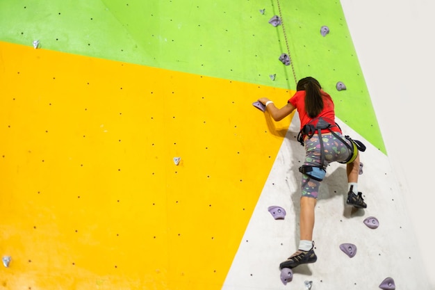 Little Girl Climbing Rock Wall