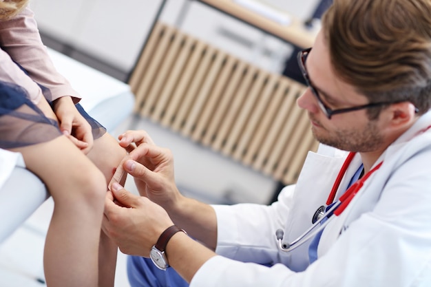 little girl in clinic being examined by dermatologist