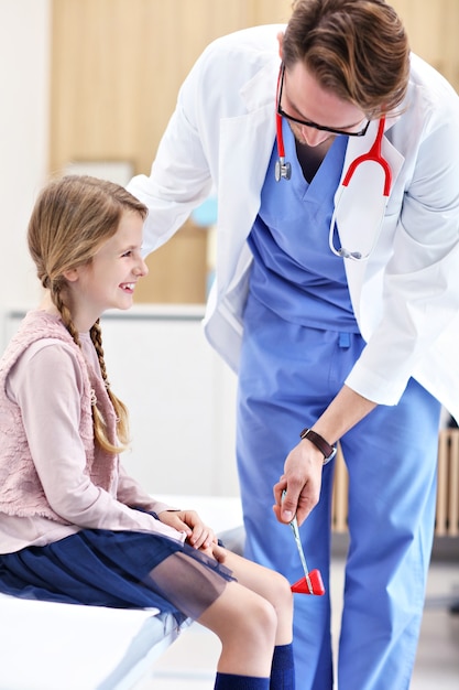 little girl in clinic being examined by neurologist