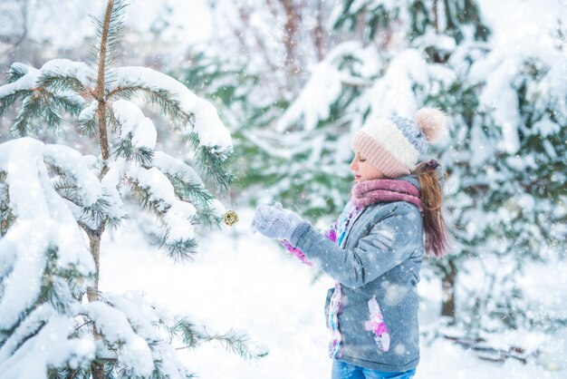 Little girl decorating christmas tree