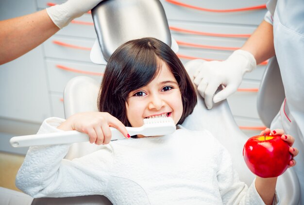Little girl at the dental office. Calm and happy.