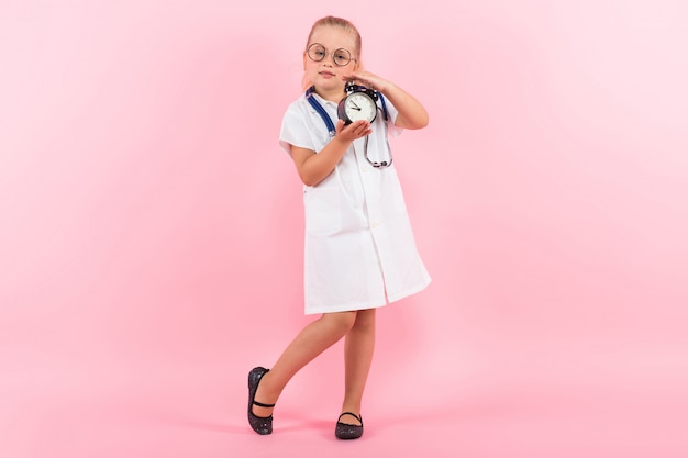 Little girl in doctor costume with clocks