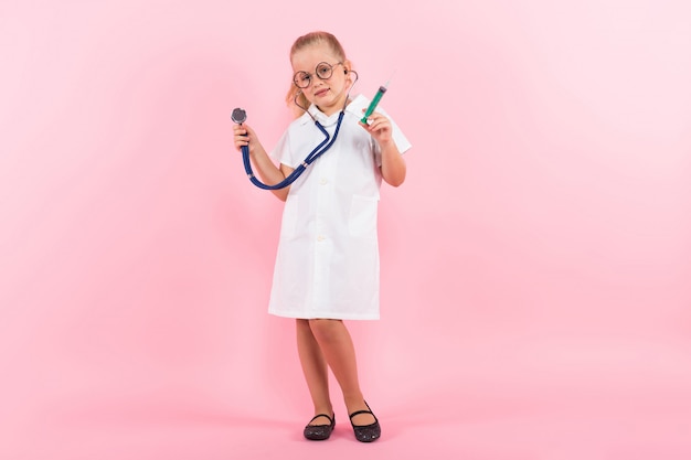 Little girl in doctor costume with injection