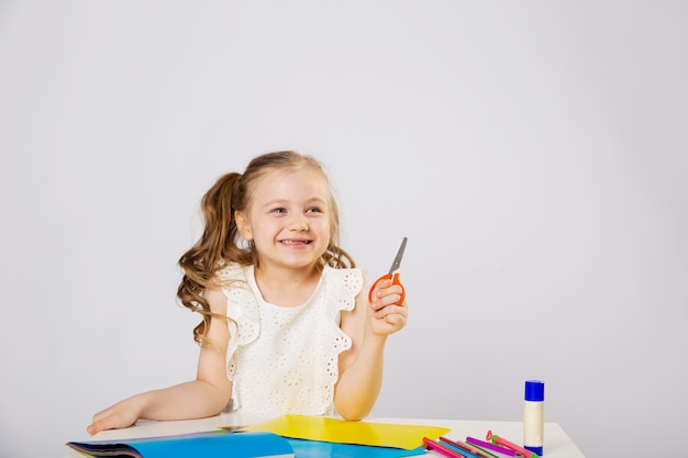 Little girl does lessons, draws, smiles