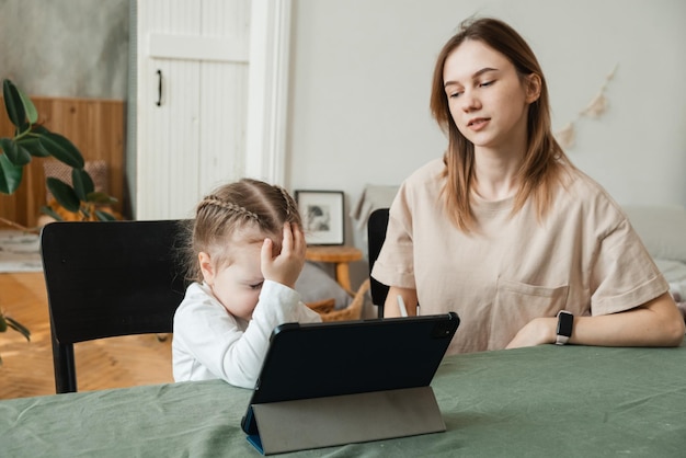 the little girl does not understand how to do homework or solve a problem stressed mother