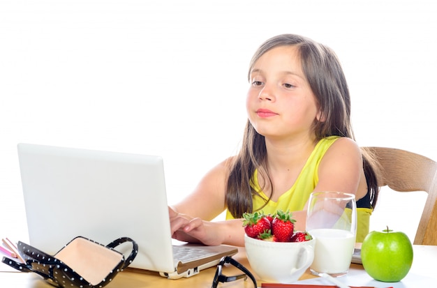 A little girl doing her homework on her computer