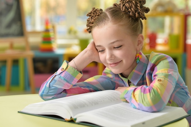 Little girl doing homework in her room