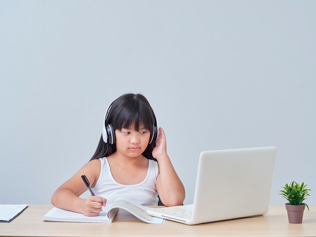 Little girl doing online class