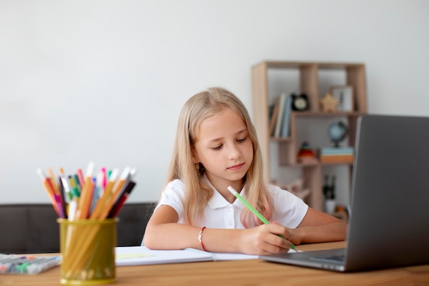 Little girl doing online classes